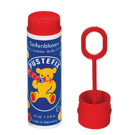 Small bottle of Pustefix bubbles with a red lid and a yellow bear on the front and red wand